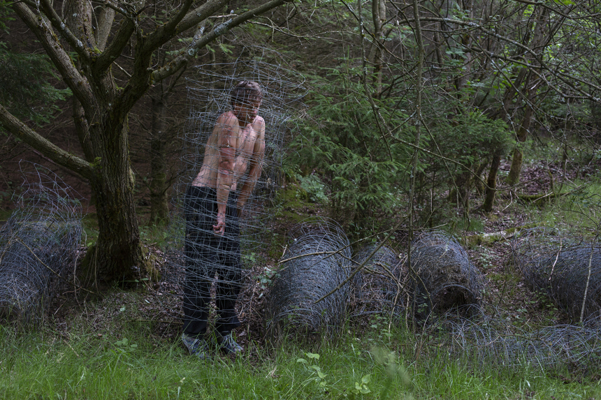 Michal Iwanowski, squeezing through wire, Go Home Polish, Adventure Uncovered